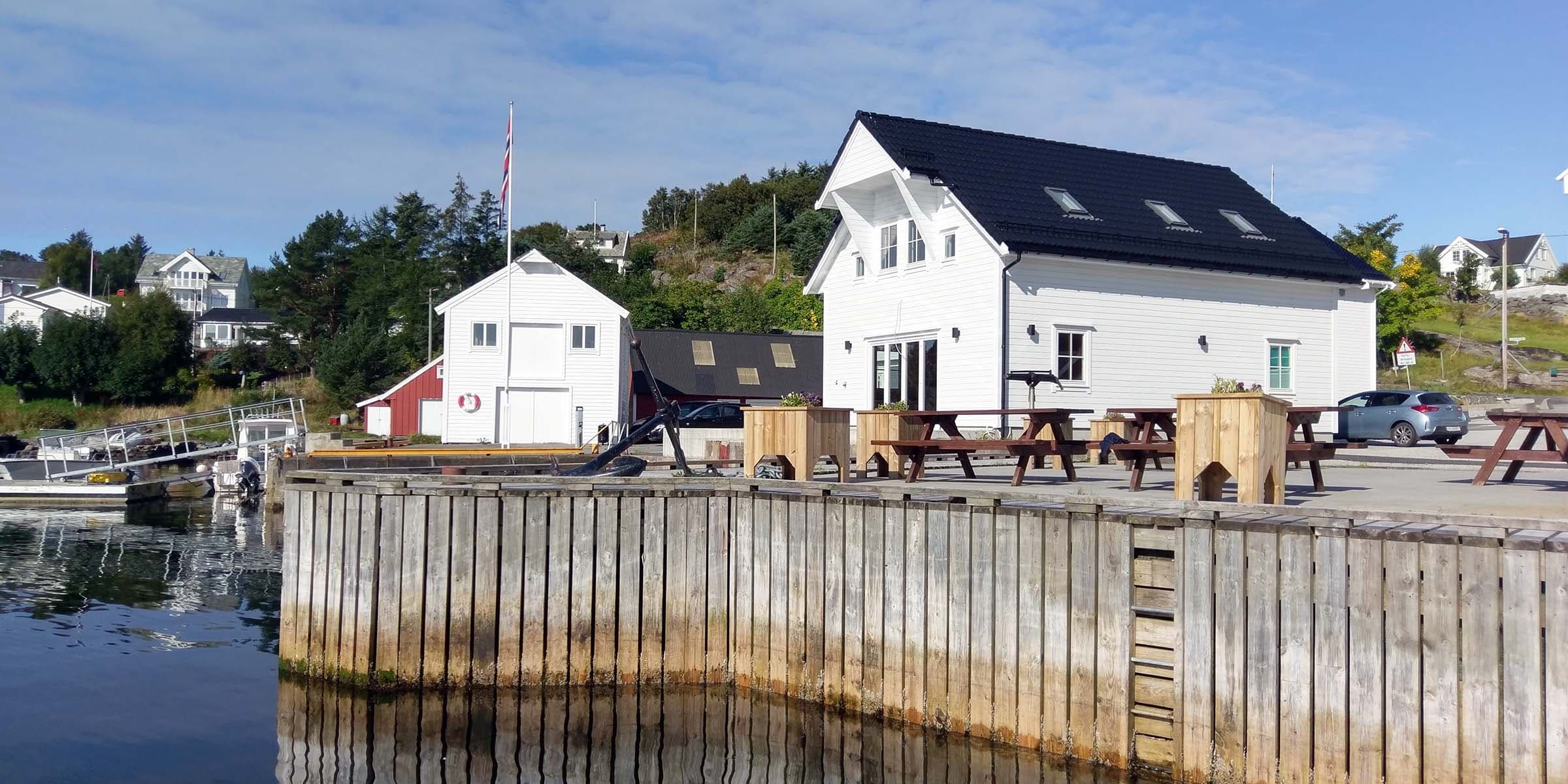 White buildings on a wooden dock overlooking the water